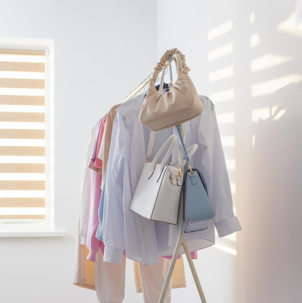 Female summer wardrobe in white room