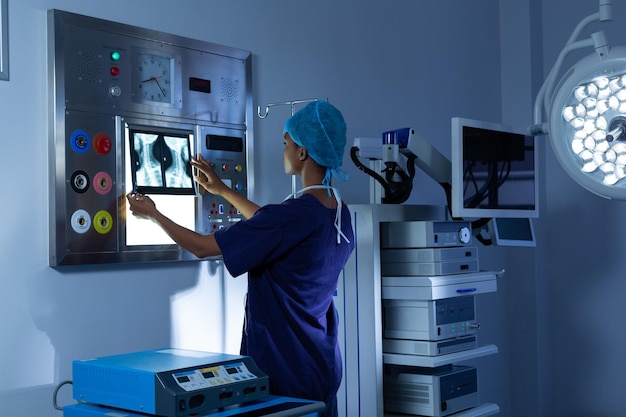 Female surgeon examining xray on a light box in the hospital