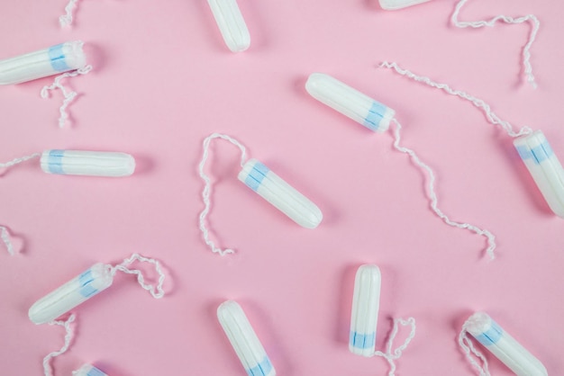 Female tampons on a pink background Hygienic white tampon for women Cotton swab Menstruation