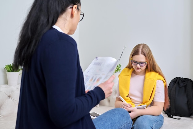 Female teacher teaching individually lesson for preteen girl