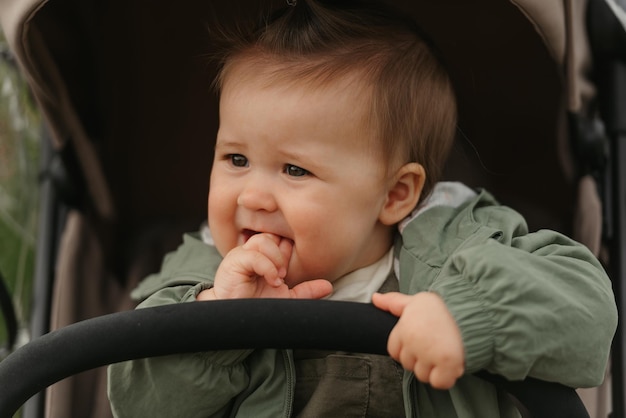 A female toddler is sitting in the stroller on a cloudy day