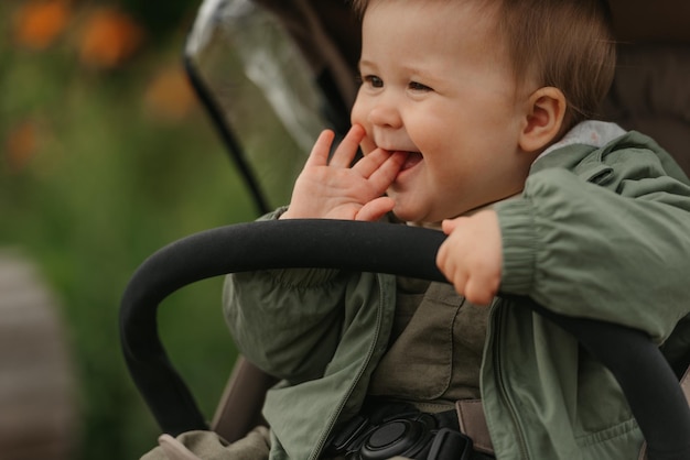 A female toddler is sitting in the stroller on a cloudy day