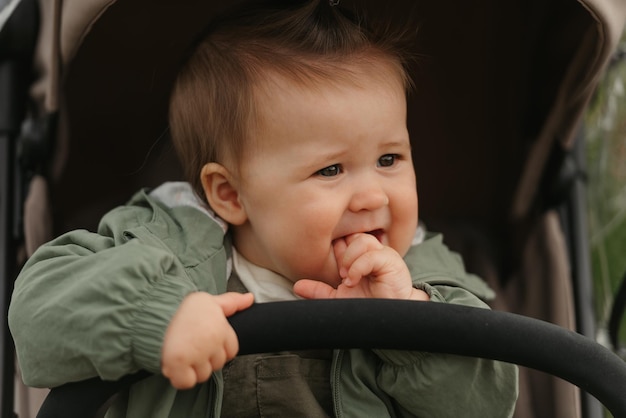 A female toddler is sitting in the stroller on a cloudy day