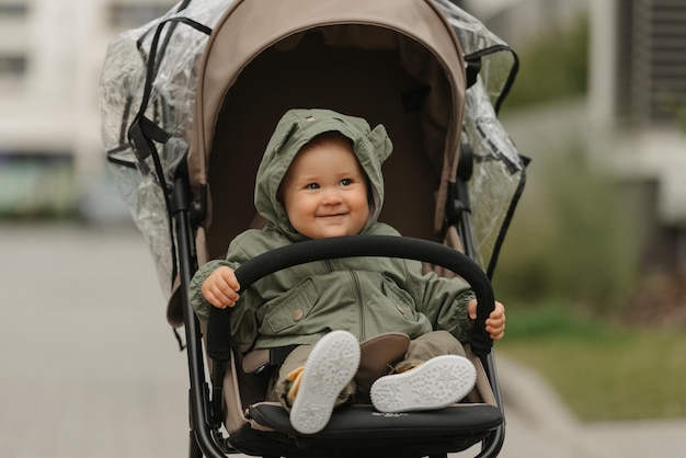 A female toddler is sitting in the stroller on a cloudy day