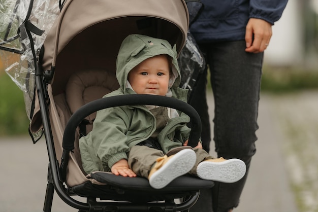 A female toddler is sitting in the stroller on a cloudy day