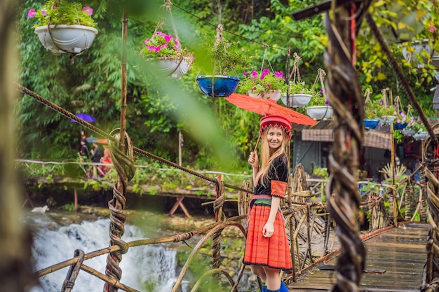 A female tourist dressed in the traditional dress of the inhabitants of the vietnamese mountains the