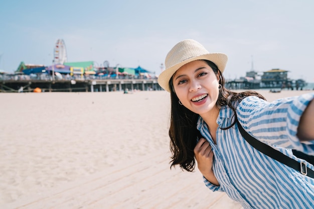 a female traveler taking selfie with an attractive smile on he face