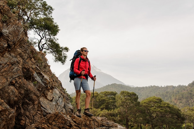 Female traveller hiking on hills on coast