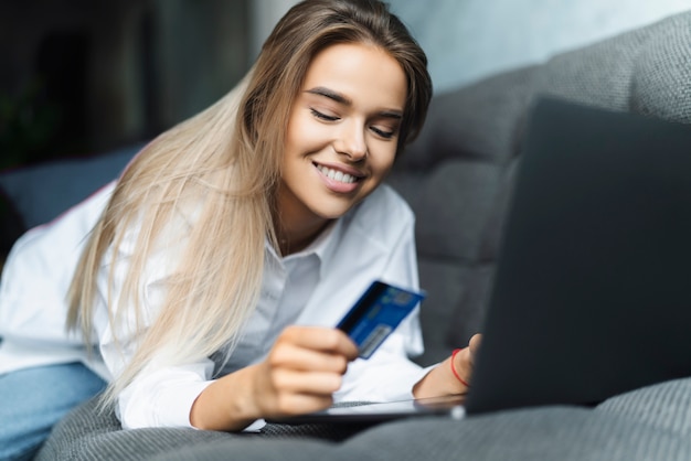 Female using bank card to pay for goods purchased online