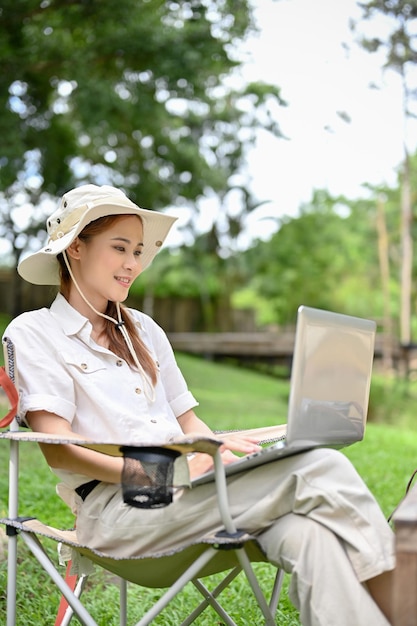 Female using laptop remote working while taking a vacation at the campground