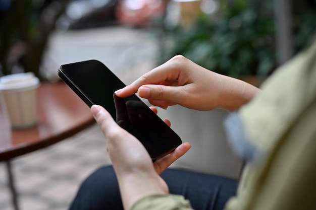 A female using mobile phone typing on smartphone screen scrolling on the phone