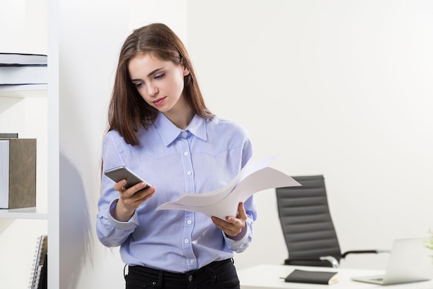 Female using phone in office