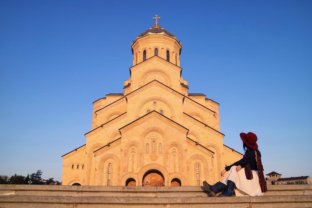 Female Visitor Sitting on Staircase of Holy Trinity Cathedral of Tbilisi  Georgia