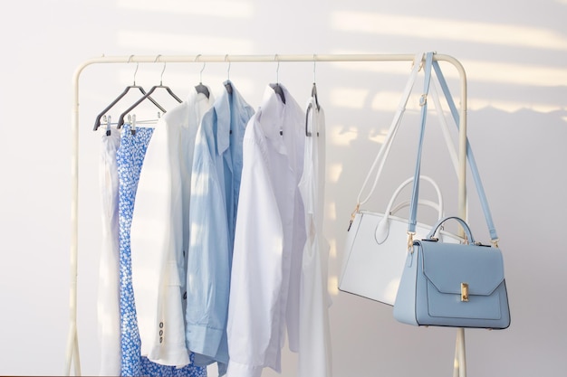 Female white and blue capsule summer wardrobe in white room