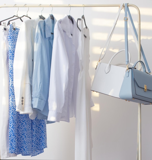 female white and blue capsule summer wardrobe in white room