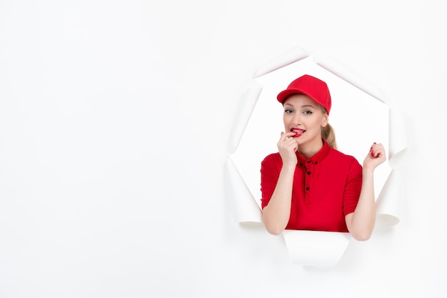 Female worker in red uniform on white