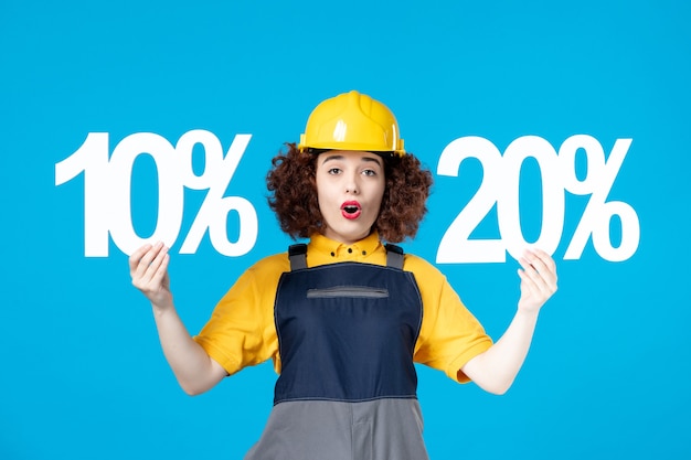 Female worker in uniform with and signs on blue