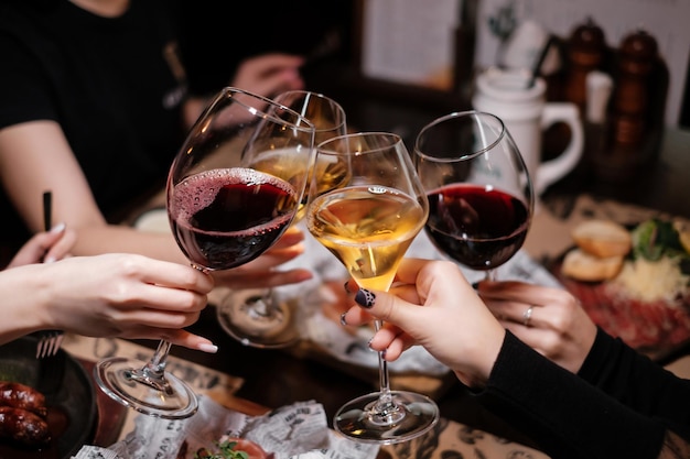 Females making cheers in restaurant