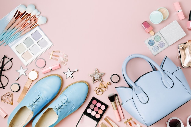 Feminine accessories collage with handbag, shoes and beauty products. Flat lay, top view. Fashion concept in pastel colored