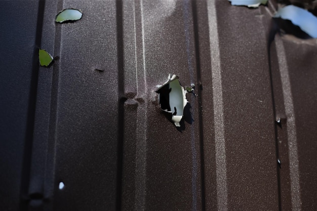 Fence near the house with bullet holes and charapnels after gunshots and fighting during the invasio