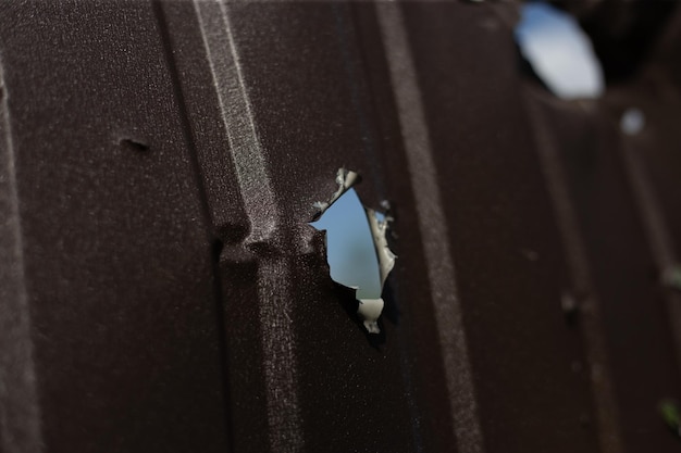 Fence near the house with bullet holes and charapnels after gunshots and fighting during the invasio