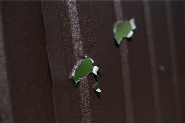 Fence near the house with bullet holes and charapnels after gunshots and fighting during the invasio