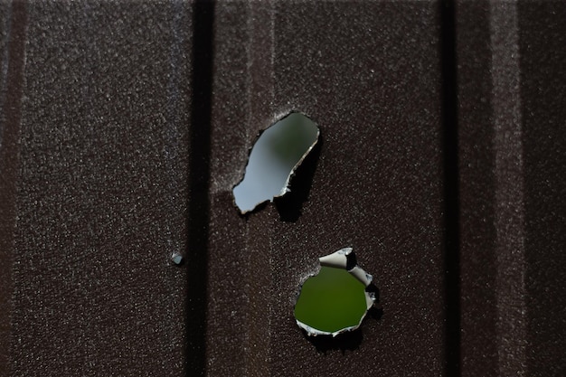 Fence near the house with bullet holes and charapnels after gunshots and fighting during the invasio