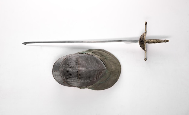 fencing helmet and sword saber rapier isolated on a white background