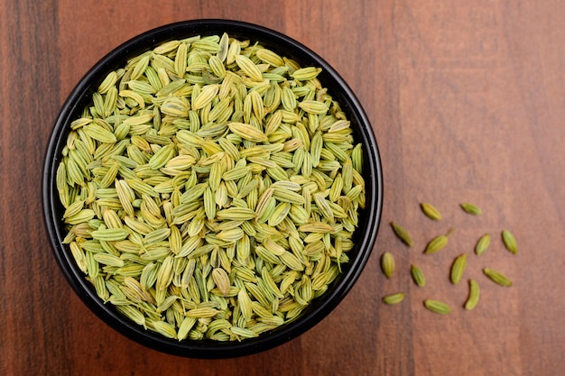 Fennel seeds top view on wooden background