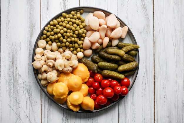 Fermented food in a plate on a white textural wooden table