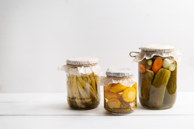 Fermented pickled vegetables in jars. Marinated food.