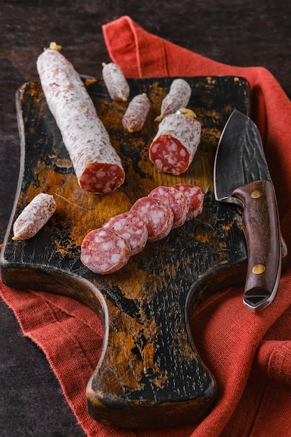 Fermented salami sausages on wooden cutting board