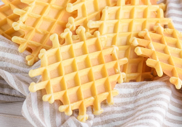 Ferratelle or pizzelle a traditional dessert or cookies from abruzzo on a cotton napkin on light