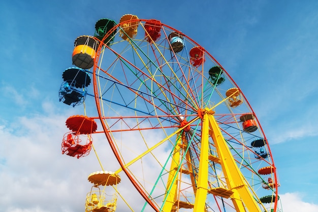 Ferris wheel against clear blue sky in amusement park