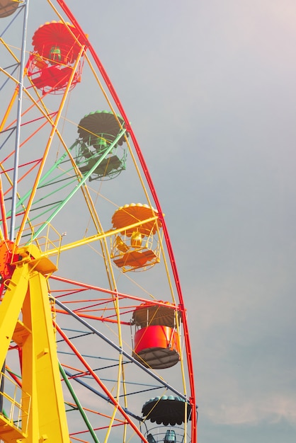 Ferris wheel against clear blue sky in amusement park