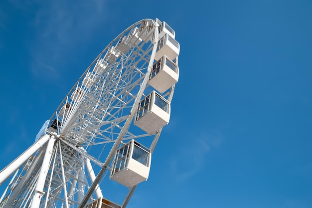 Ferris wheel on blue sky background