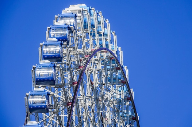 Ferris wheel on the blue sky