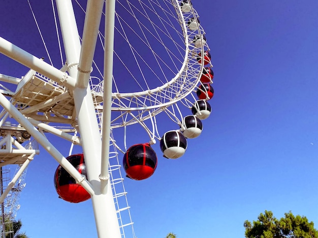 Ferris wheel in the city against the blue sky carousel for riding attraction for a sightseeing tour