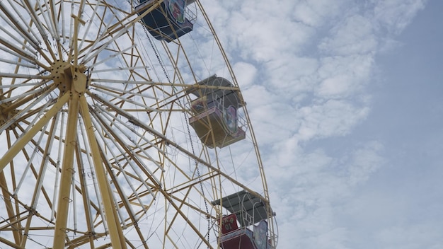 a ferris wheel with a red and white top and a yellow top