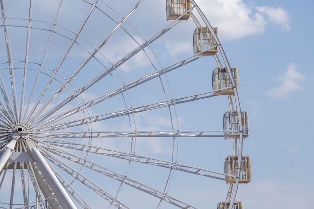 Ferris white wheel over blue sky background