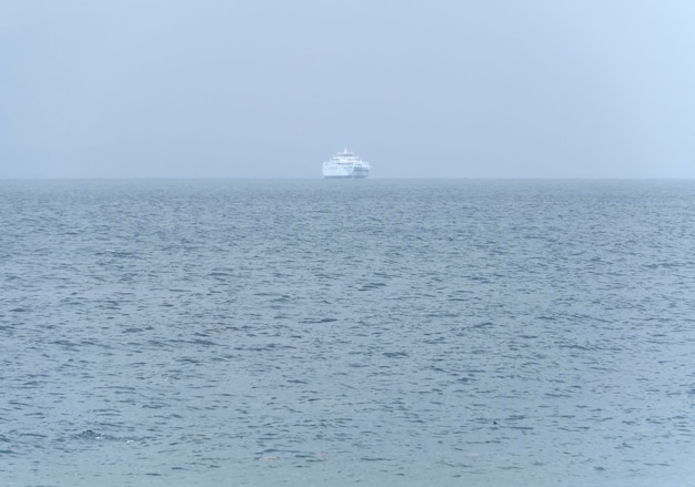 Ferry boat on the horizon in the Aegean Sea in a storm in Greece