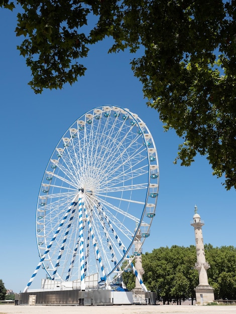 Ferry wheel on the Esplanade de Quinconces near the monument of Aux Girondins in Bordeaux France