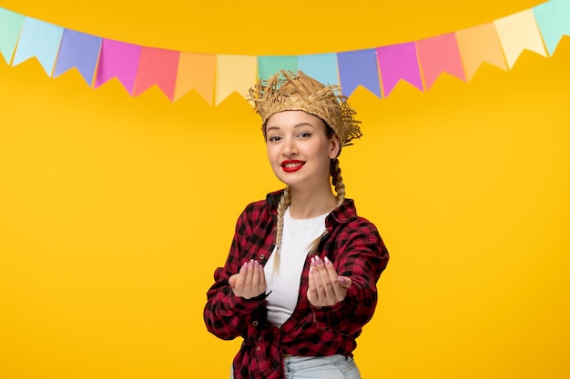 Festa junina blonde cute girl in straw hat brazilian festival with colorful flags inviting hands