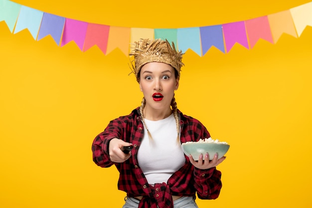 Festa junina blonde cute girl in straw hat brazilian festival with colorful flags shocked