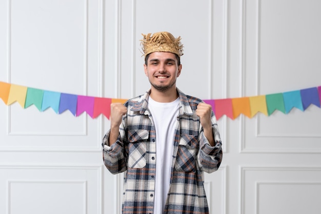 Festa junina handsome guy in checked shirt in straw hat celebrating festival super excited