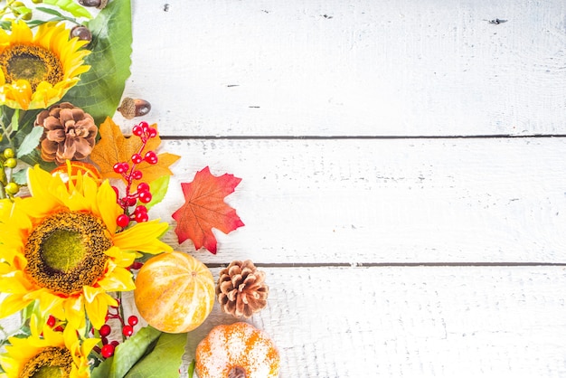 Festive autumn background, still life decor with pumpkins, berries, leaves on white wooden background. Concept background for Thanksgiving or Halloween holiday, copy space, flatlay