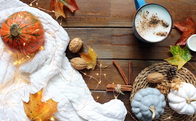 Festive autumn decor from pumpkins berries and leaves on a wooden background Concept of Thanksgiving day or Halloween Flat lay autumn composition with copy space