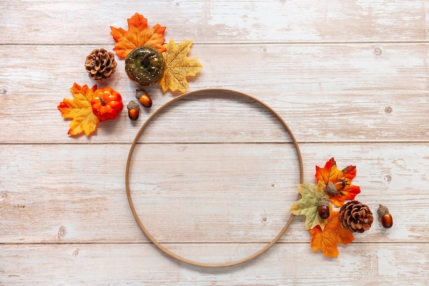 Festive autumn decor from pumpkins leaves and acorns on a wooden background