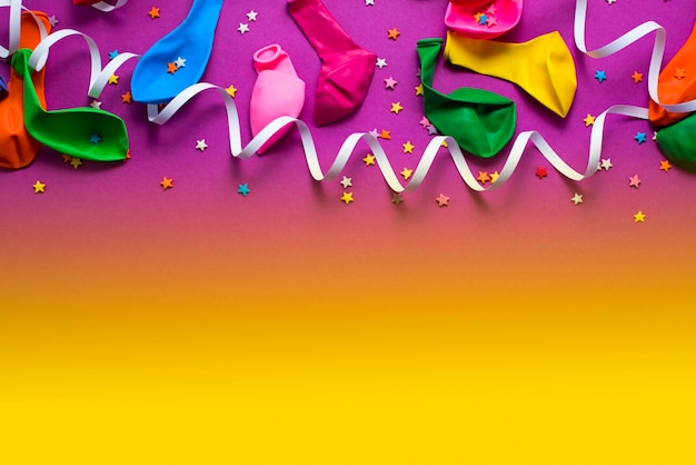 Festive background purple material colorful balloons streamers confetti 