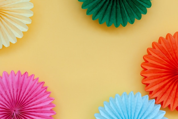 Festive Birthday colorful paper fans on pastel yellow Birthday or party